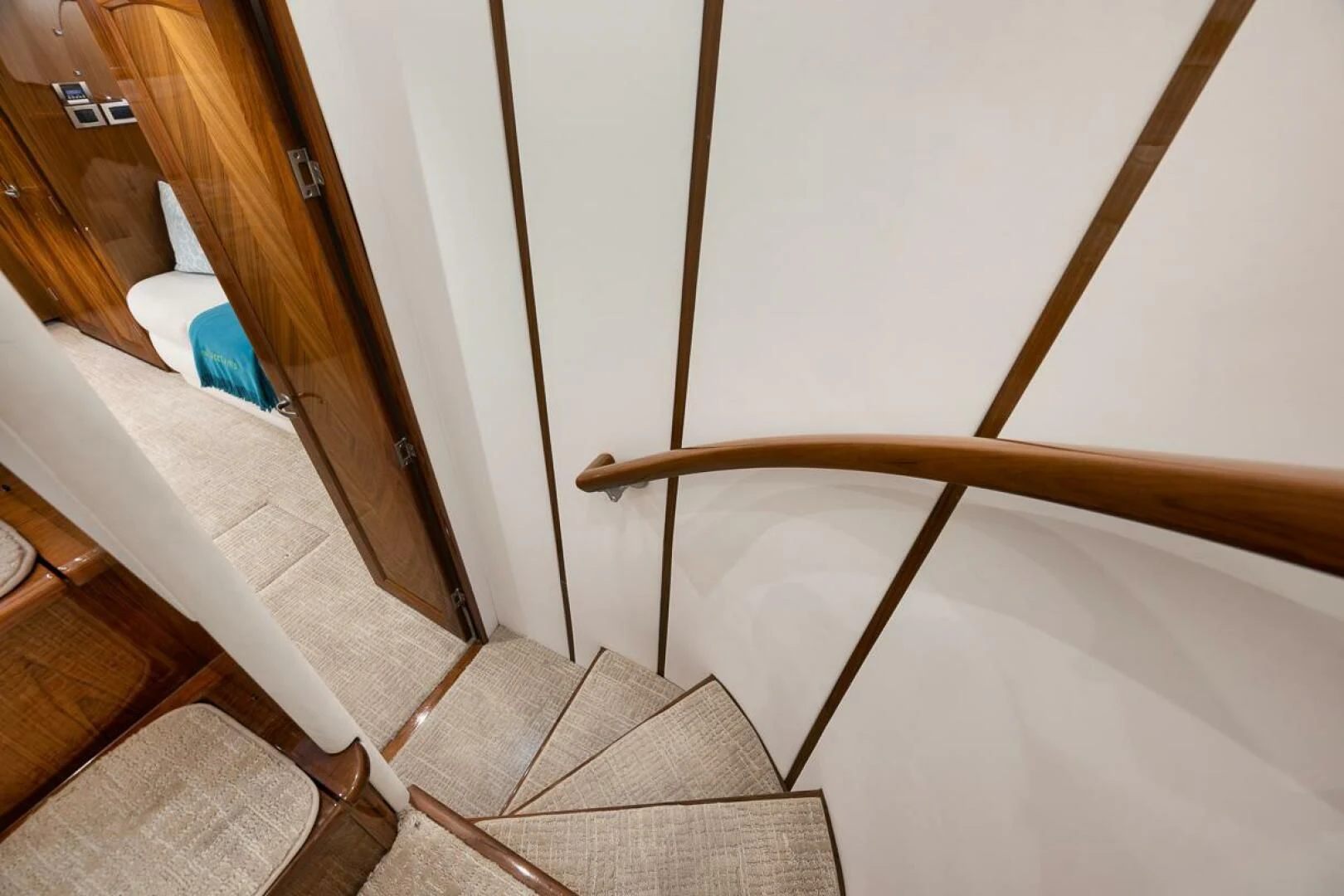 a staircase with a wood railing aboard DOC Z Yacht for Sale