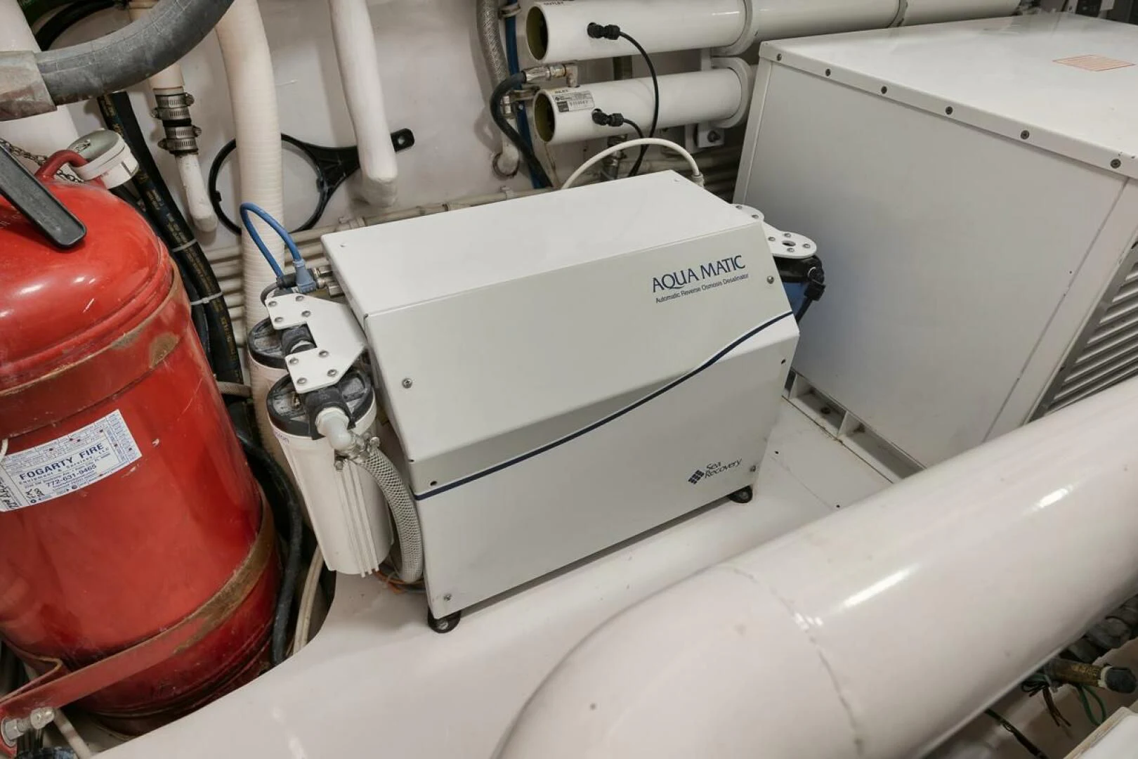 a toilet with a sink and a red bucket aboard DOC Z Yacht for Sale