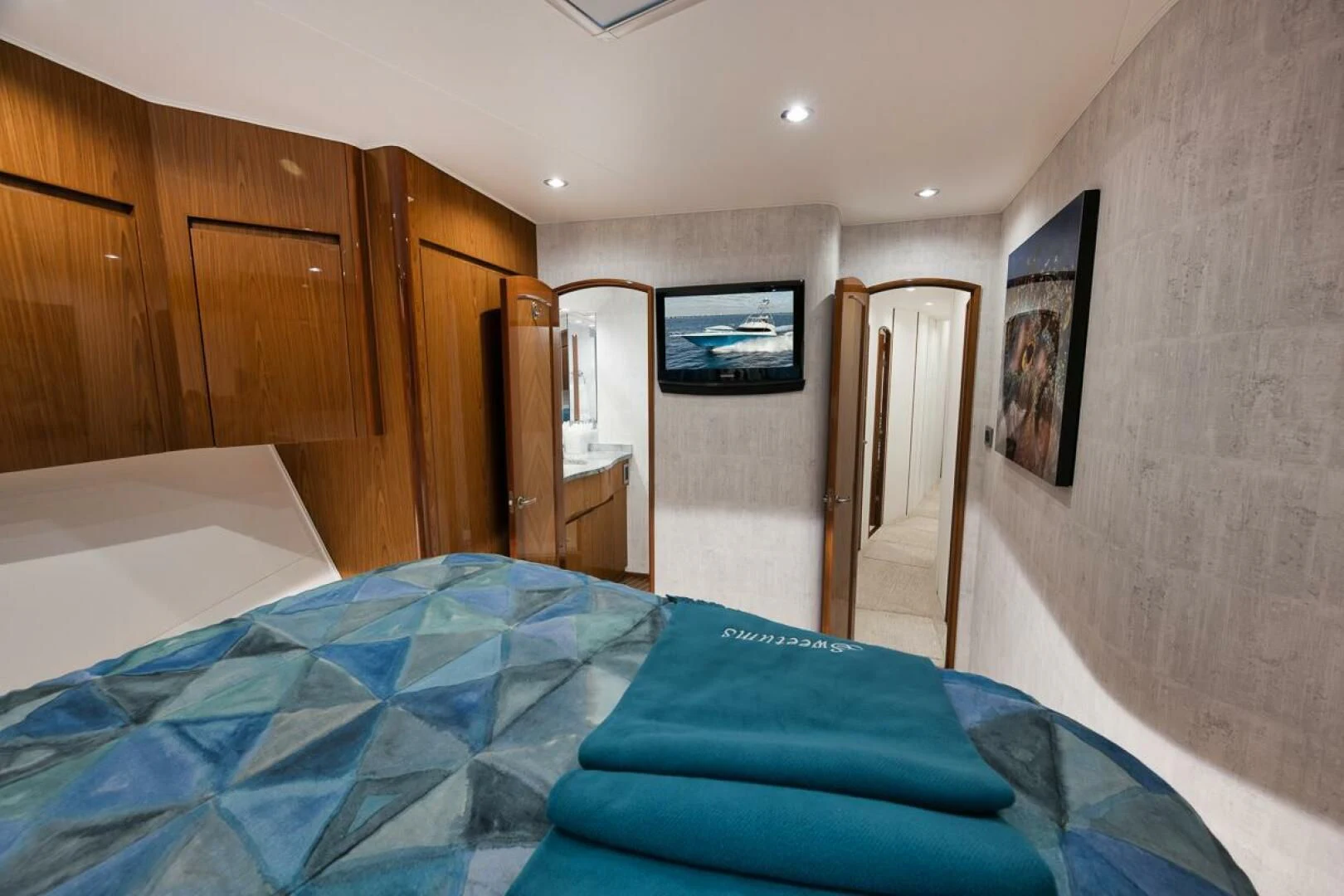 a bedroom with a bed and a television aboard DOC Z Yacht for Sale