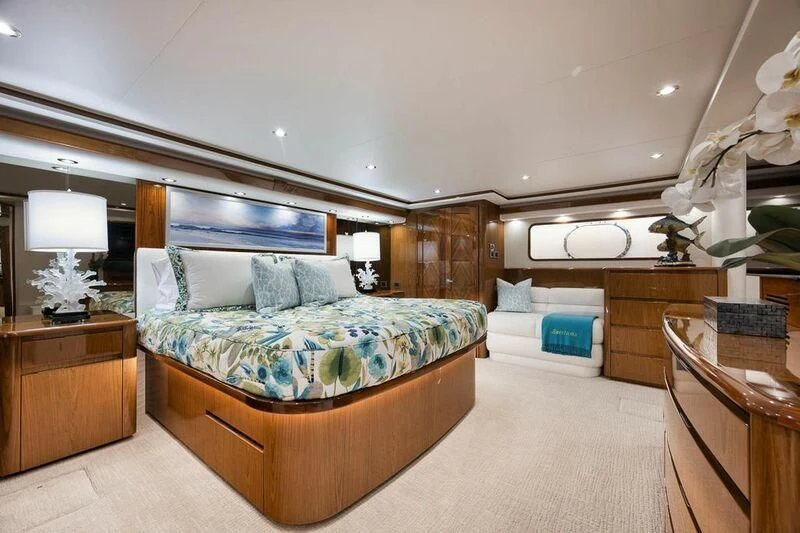 a bedroom with a bed and a dresser aboard DOC Z Yacht for Sale