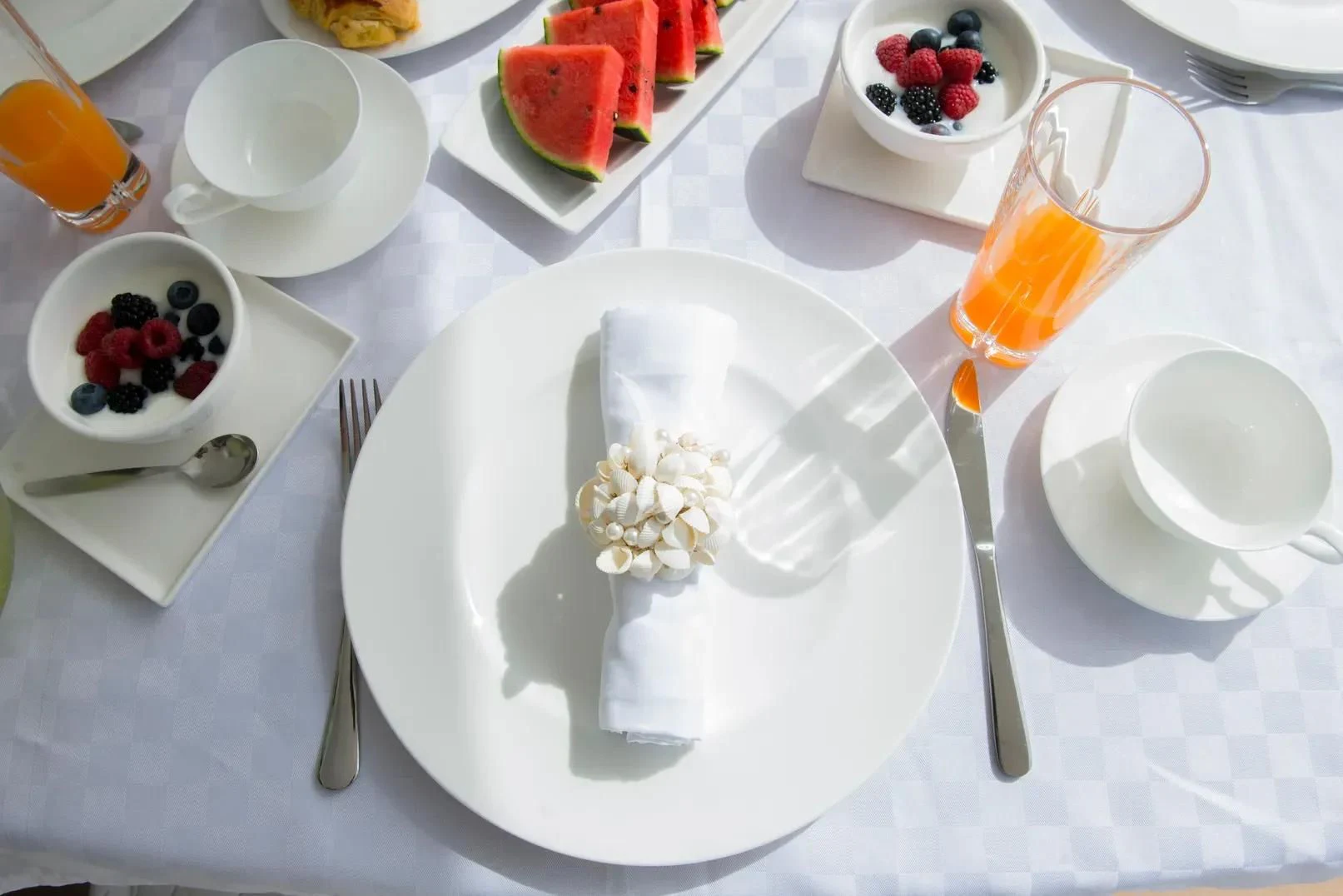 a table with plates and glasses aboard LIGHT BLUE Yacht for Sale