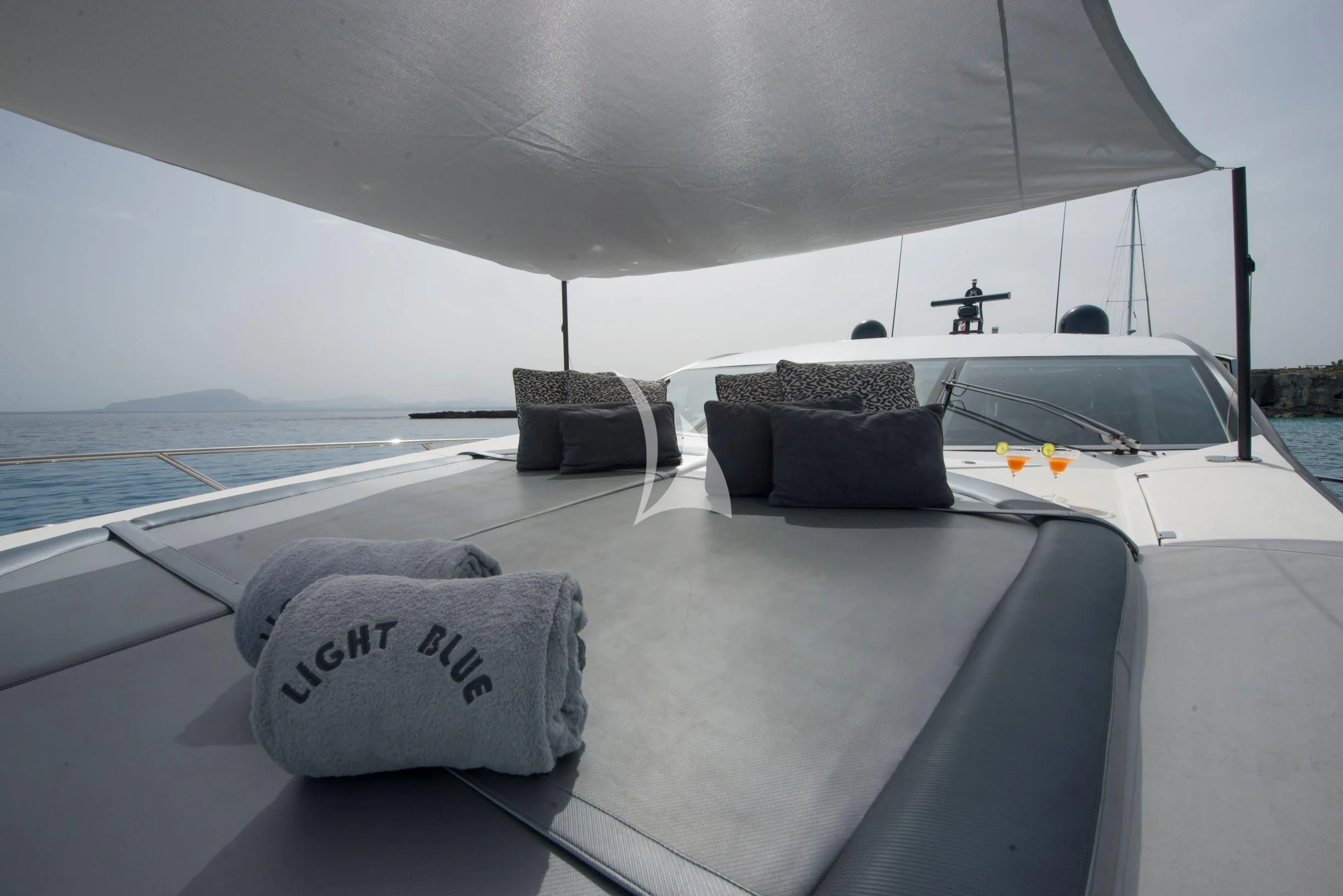a white boat on a beach aboard LIGHT BLUE Yacht for Sale