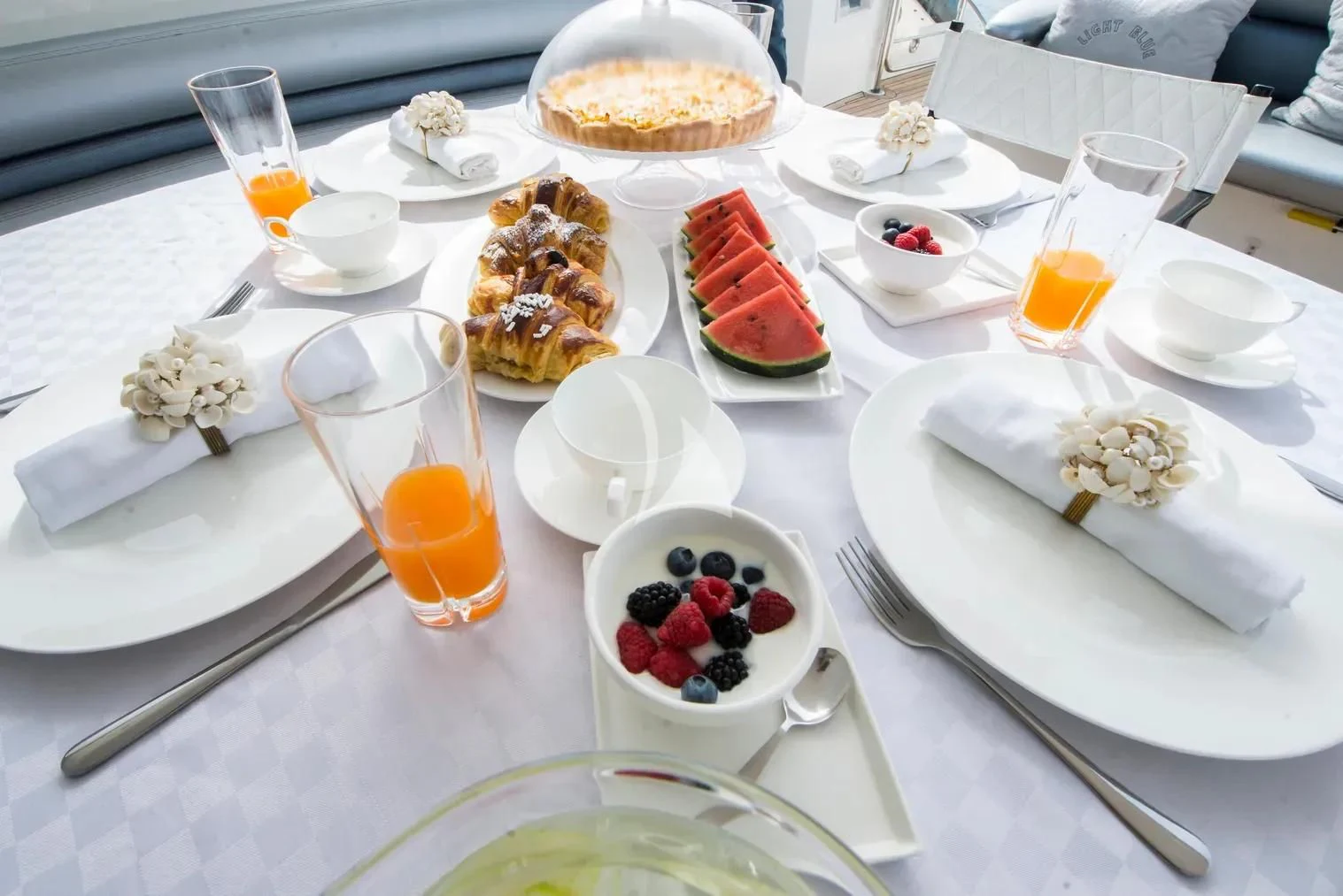 a table with food and drinks aboard LIGHT BLUE Yacht for Sale