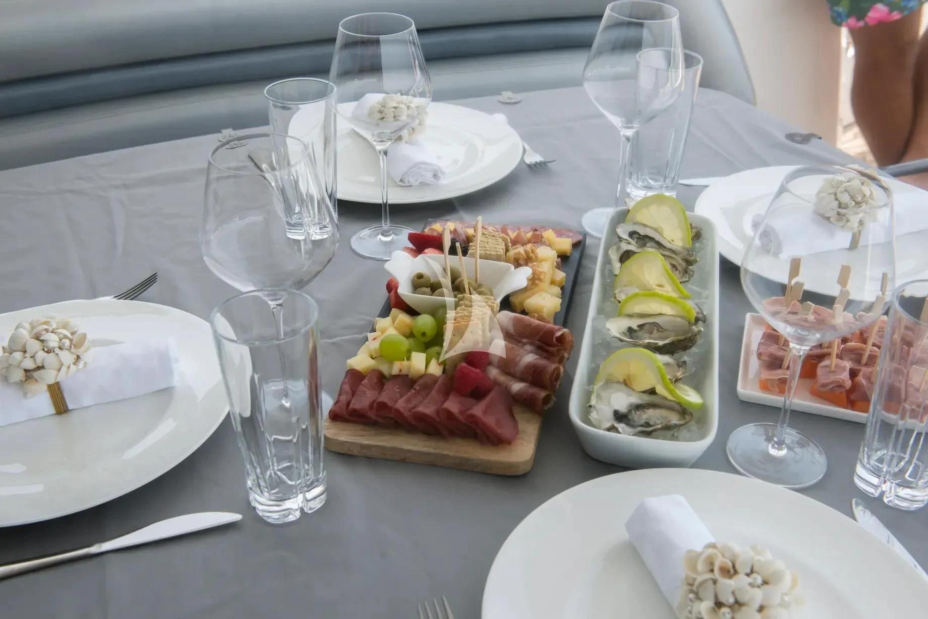 a table with food and glasses aboard LIGHT BLUE Yacht for Sale