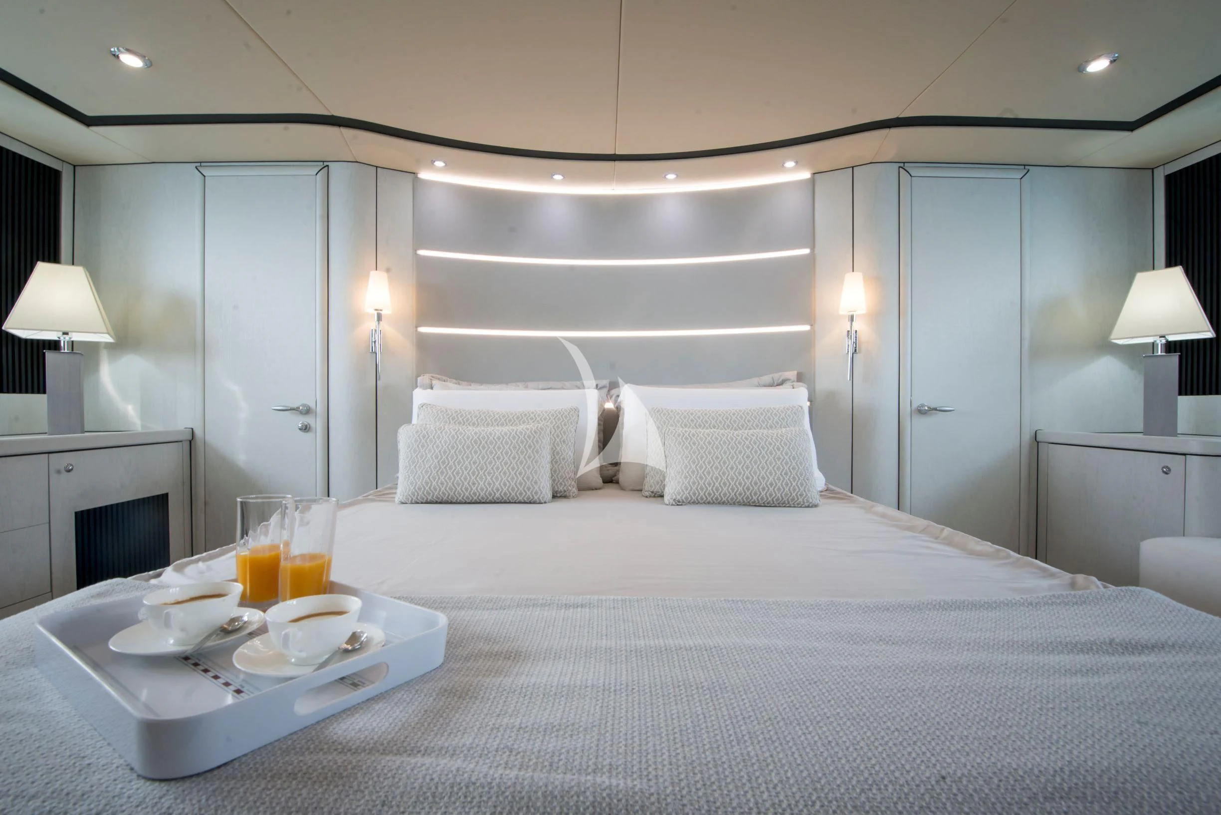 a bed with a tray of food and drinks on it aboard LIGHT BLUE Yacht for Sale