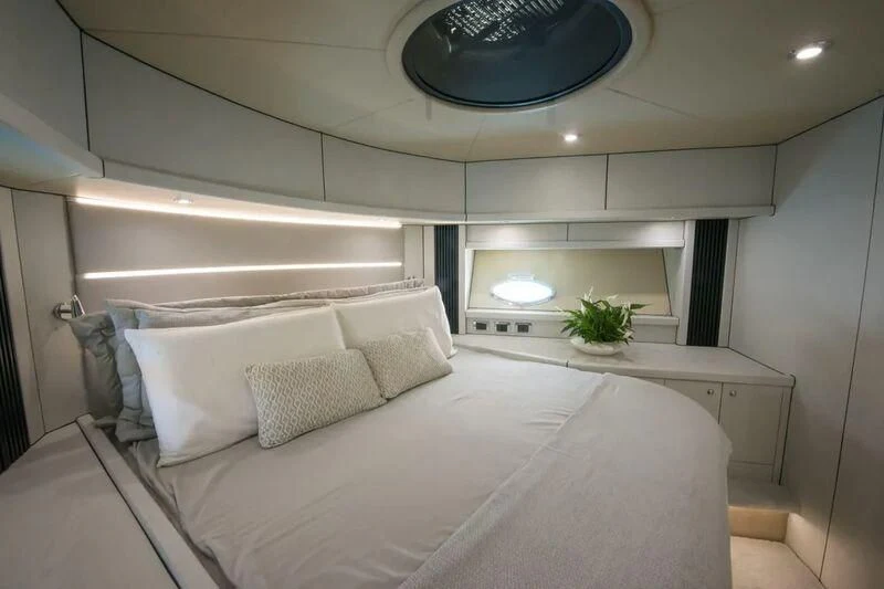 a white bedroom with a large bed aboard LIGHT BLUE Yacht for Sale