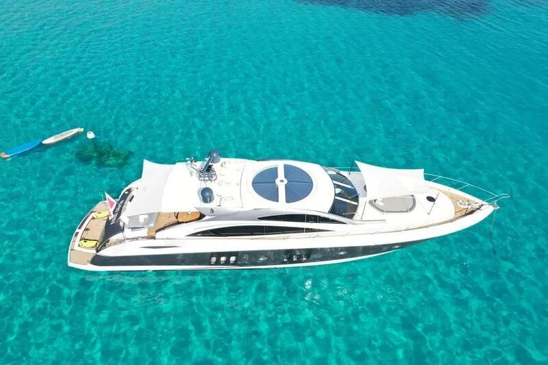 a white sports car on a green surface aboard LIGHT BLUE Yacht for Sale