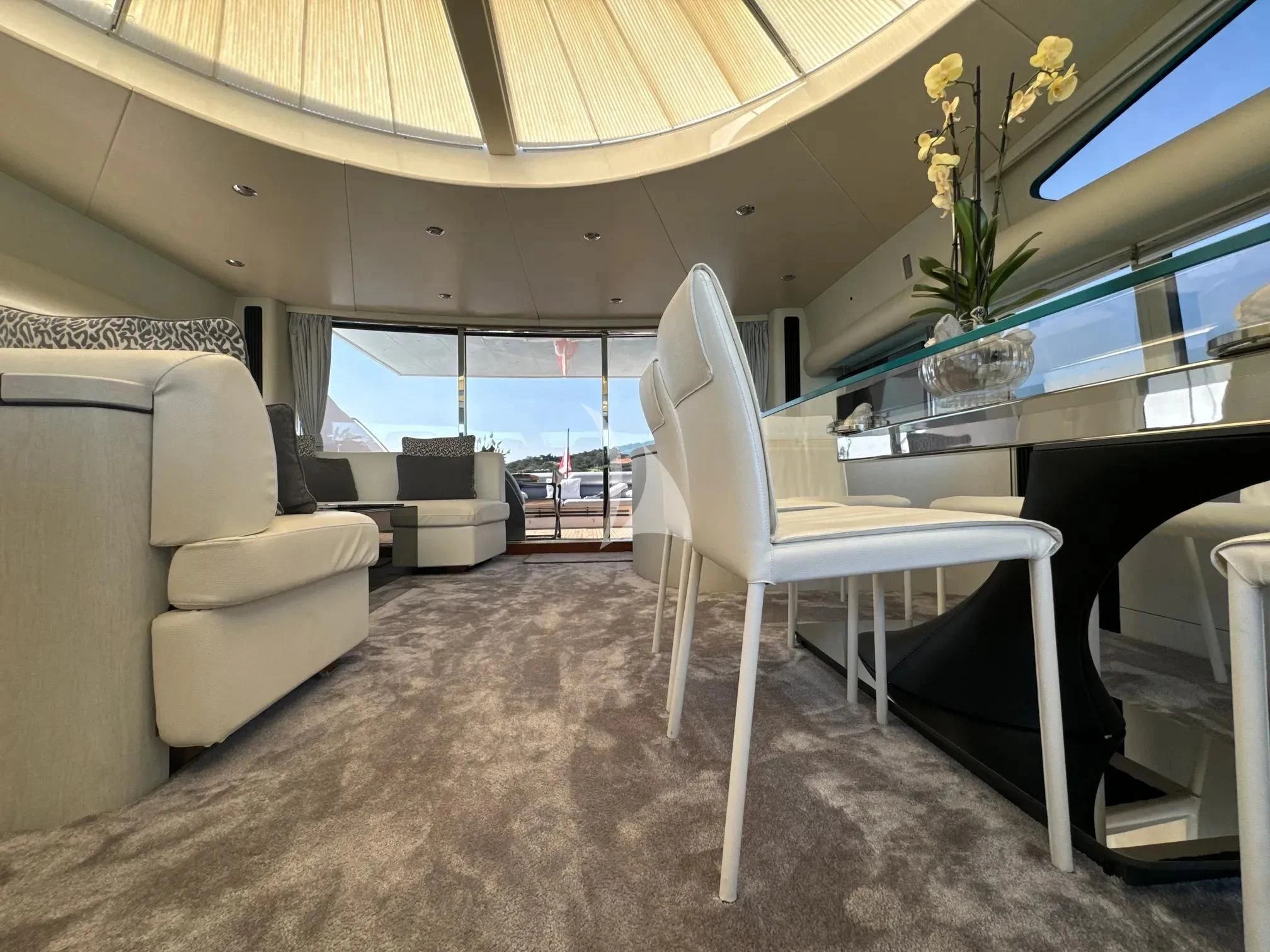 a living room with a white chair aboard LIGHT BLUE Yacht for Sale