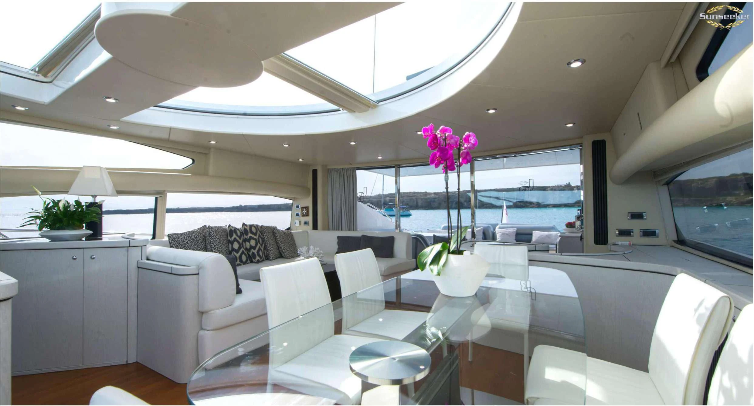 a room with a table chairs and a flower on the table aboard LIGHT BLUE Yacht for Sale