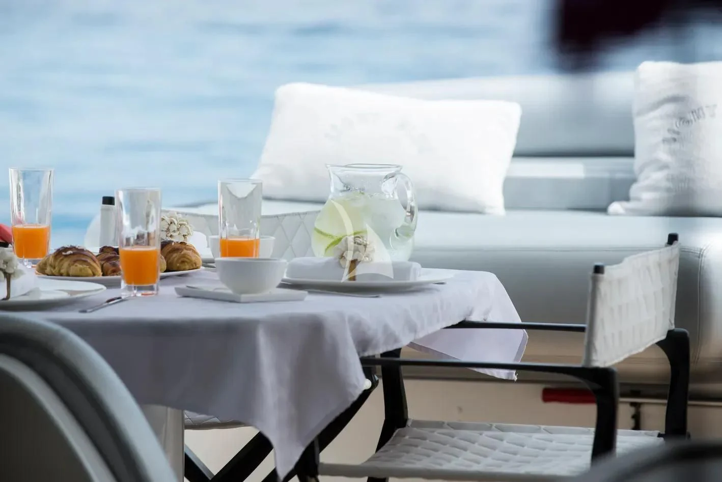 a table set with food and drinks aboard LIGHT BLUE Yacht for Sale
