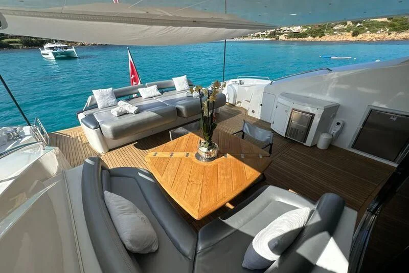 a room with a table and chairs on it by a body of water aboard LIGHT BLUE Yacht for Sale