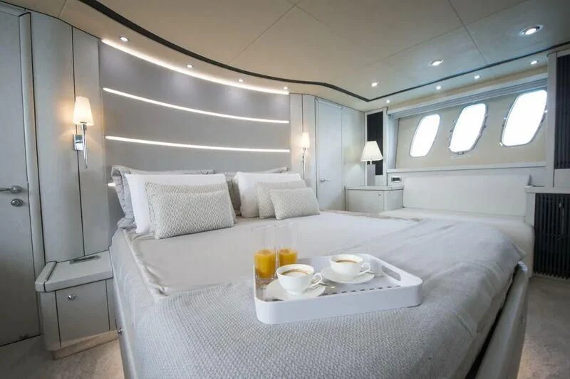 a bed with white sheets and pillows aboard LIGHT BLUE Yacht for Sale