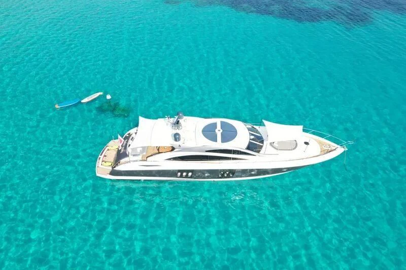 a white sports car on a green carpet aboard LIGHT BLUE Yacht for Sale