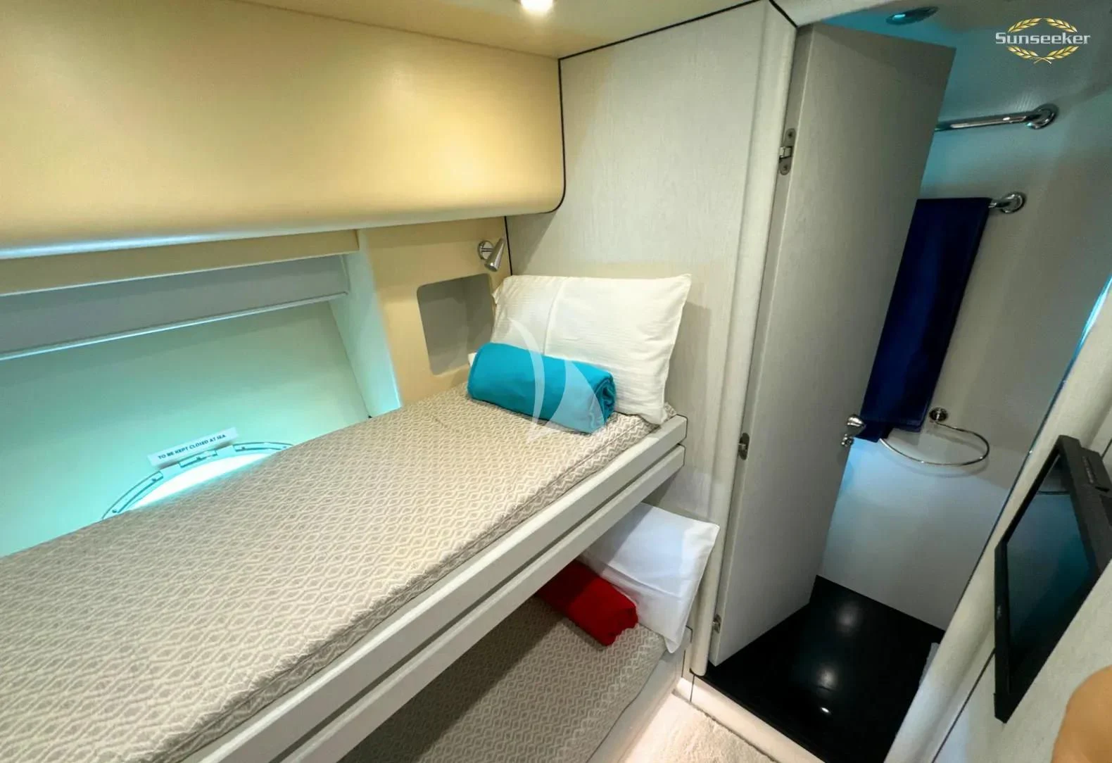 a room with a bed and a television aboard LIGHT BLUE Yacht for Sale