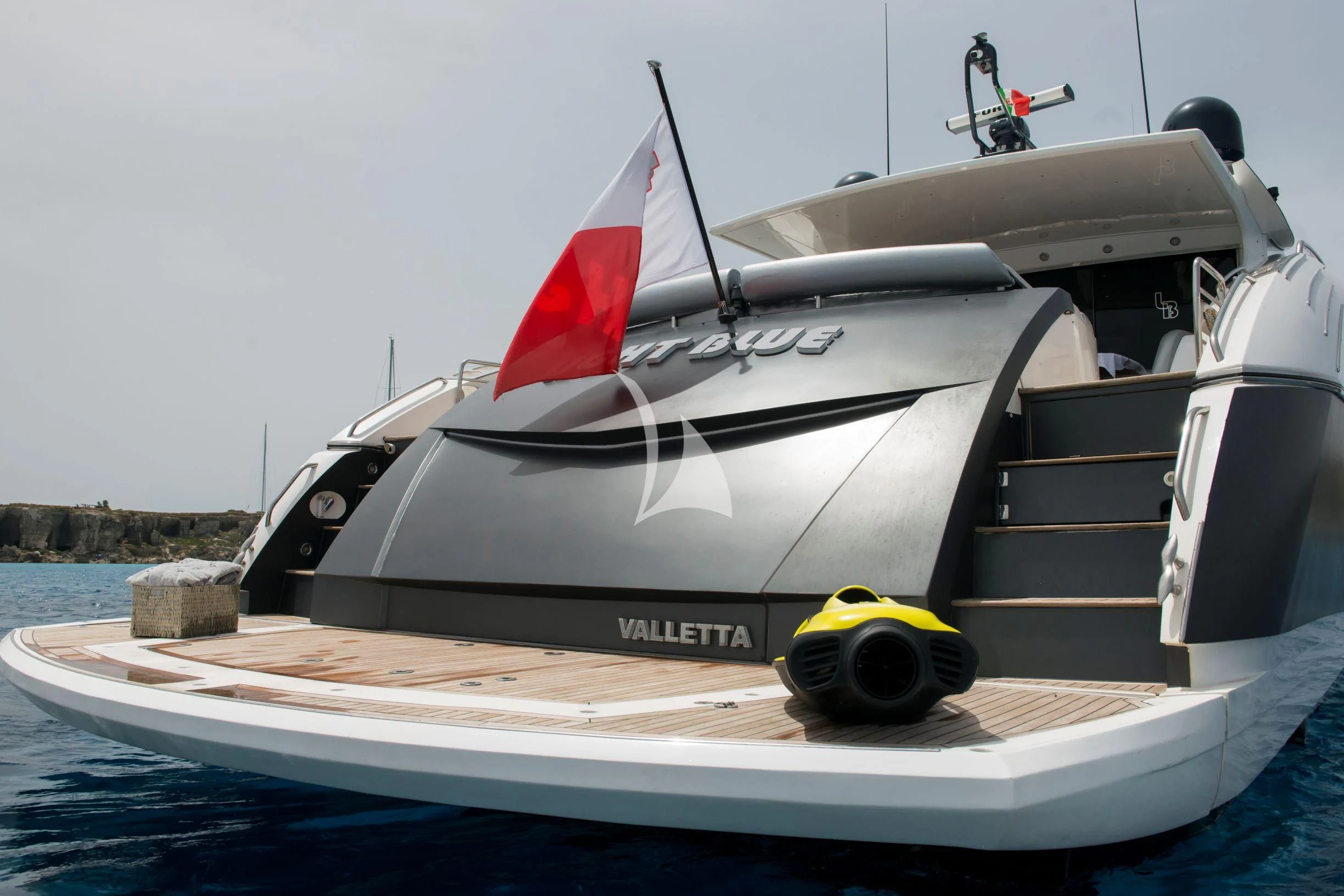 a boat with a flag on the front aboard LIGHT BLUE Yacht for Sale