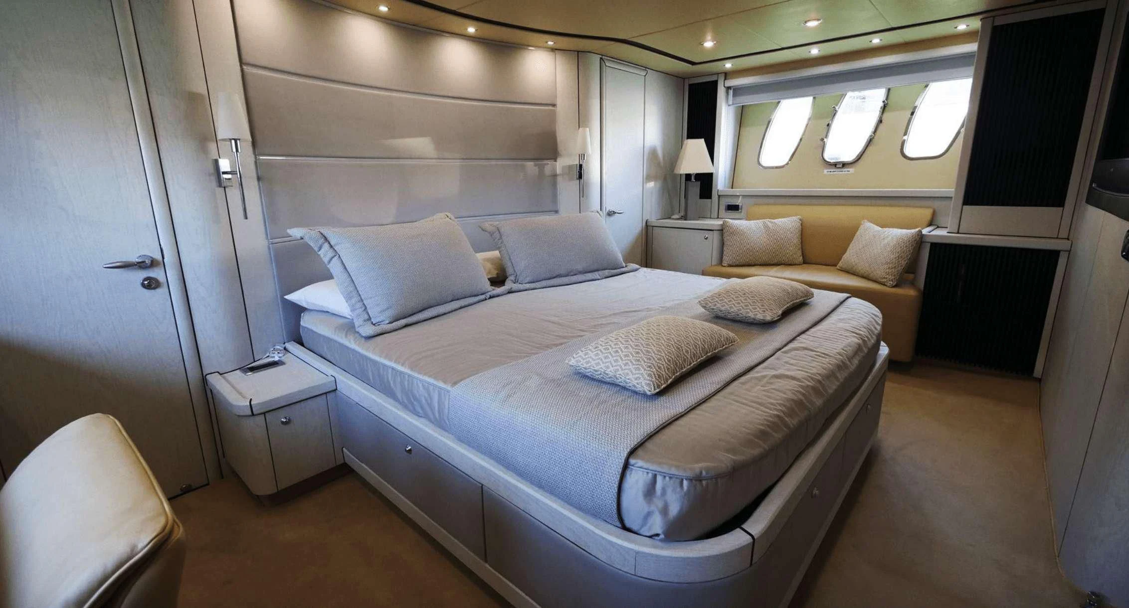 a room with a bed and a couch aboard LIGHT BLUE Yacht for Sale