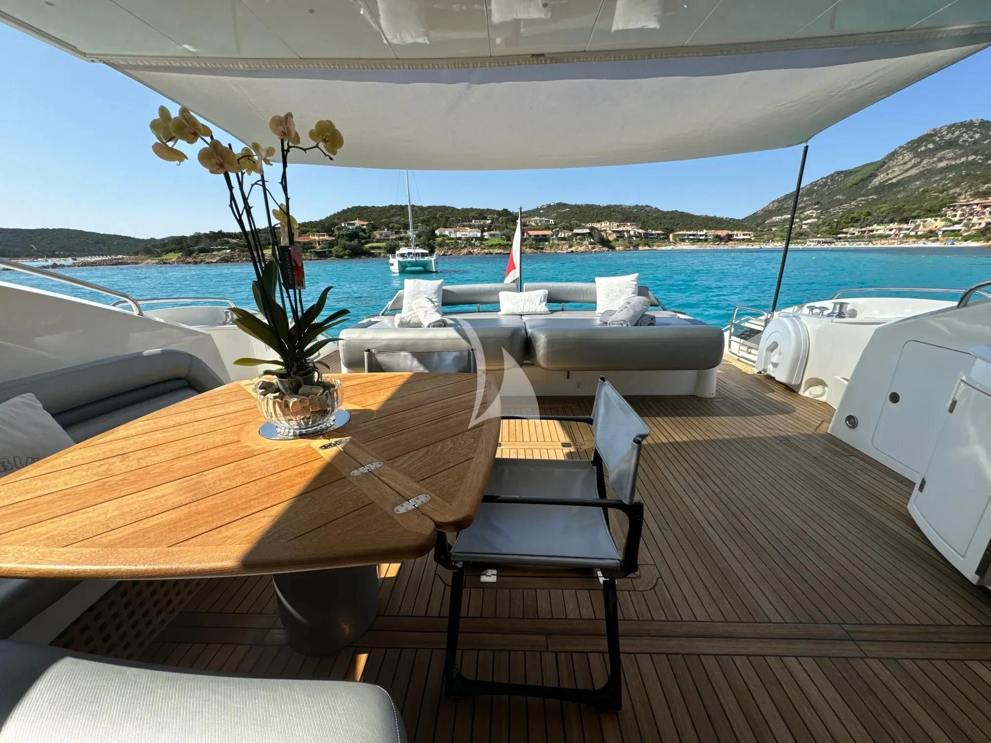 a table with chairs on it next to a body of water aboard LIGHT BLUE Yacht for Sale