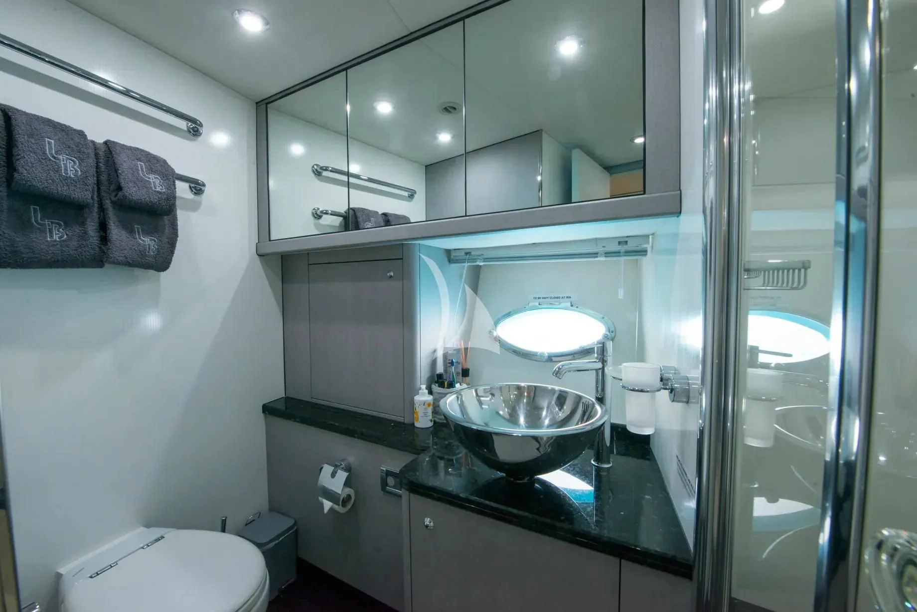 a bathroom with a large mirror aboard LIGHT BLUE Yacht for Sale