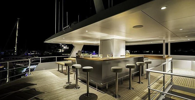 a room with stools and tables aboard THE BEAST Yacht for Sale
