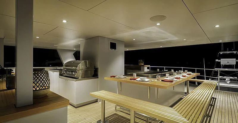 a kitchen with a table and chairs aboard THE BEAST Yacht for Sale