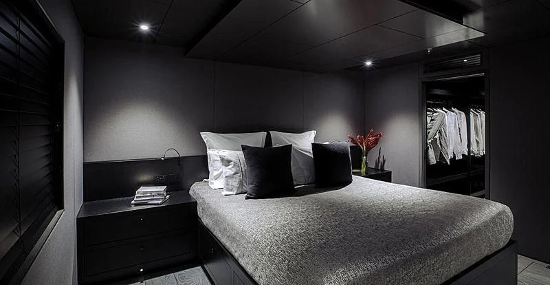 a bed with white sheets and pillows aboard THE BEAST Yacht for Sale