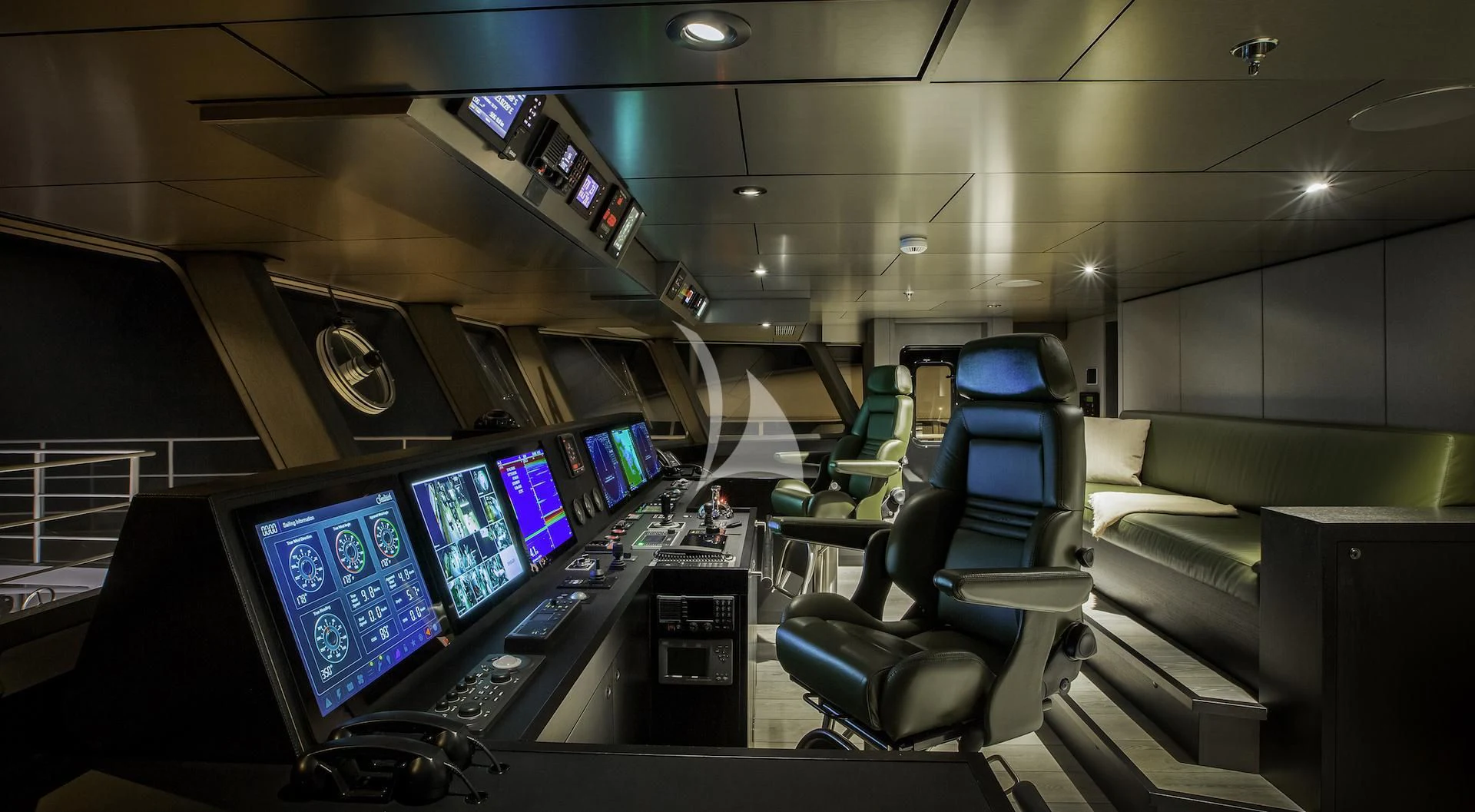 a room with several monitors and a couch aboard THE BEAST Yacht for Sale