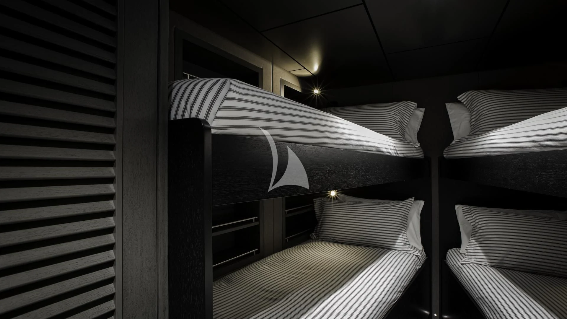 a room with a bed and a striped wall aboard THE BEAST Yacht for Sale