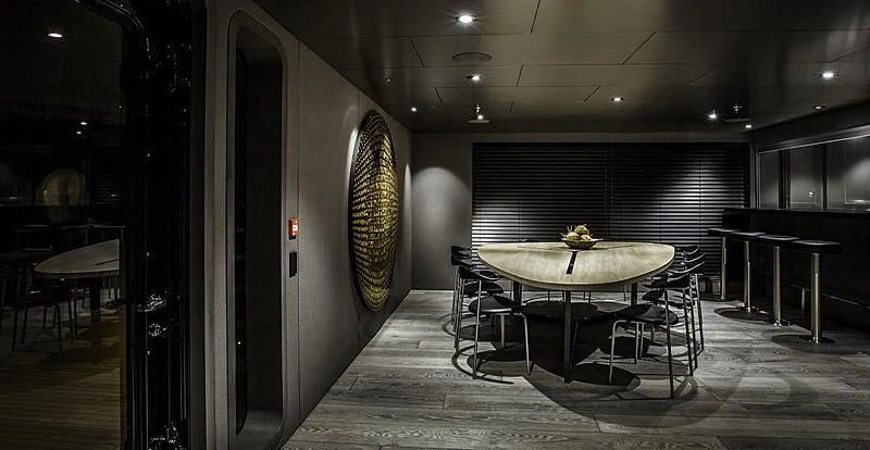a room with tables and chairs aboard THE BEAST Yacht for Sale