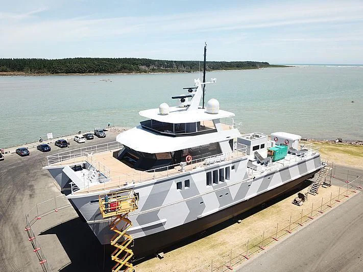 a large white boat with a ladder aboard THE BEAST Yacht for Sale