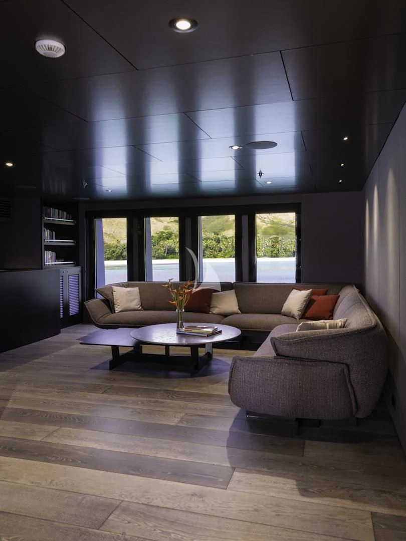 a living room with a large window aboard THE BEAST Yacht for Sale