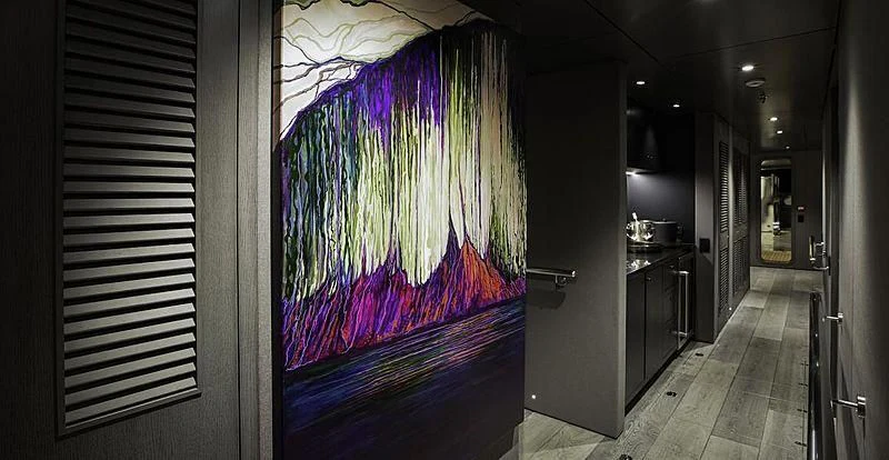 a room with a painting aboard THE BEAST Yacht for Sale