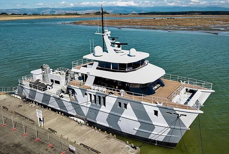 a large white boat on a dock aboard THE BEAST Yacht for Sale