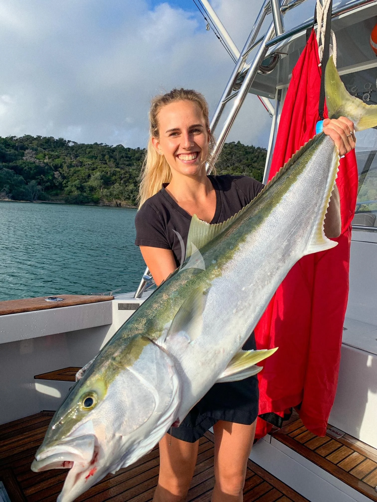 Alex Greenwood holding a fish aboard THE BEAST Yacht for Sale