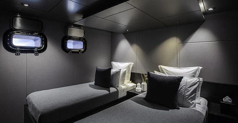 a room with two beds aboard THE BEAST Yacht for Sale