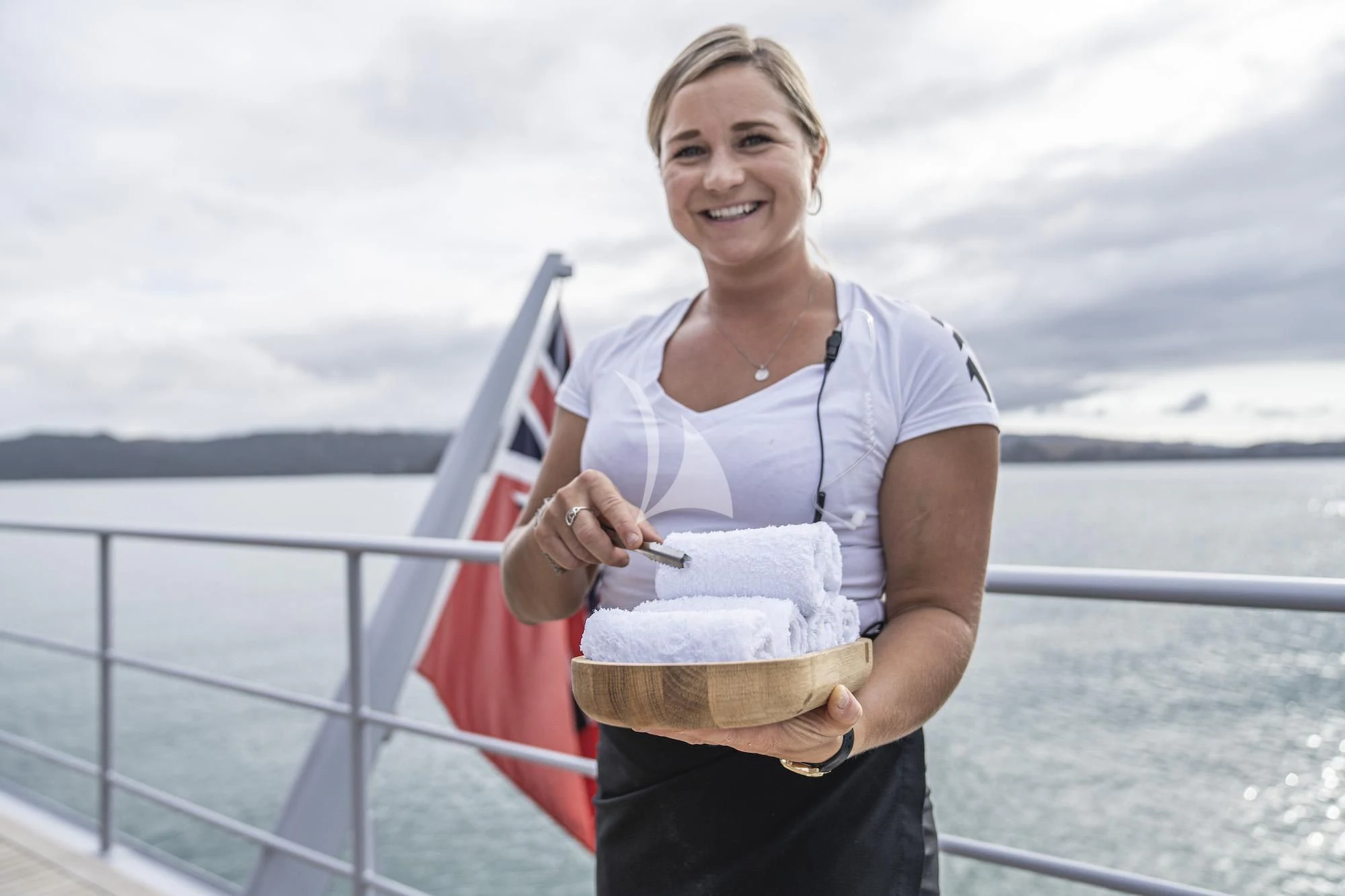 a woman holding a flag aboard THE BEAST Yacht for Sale