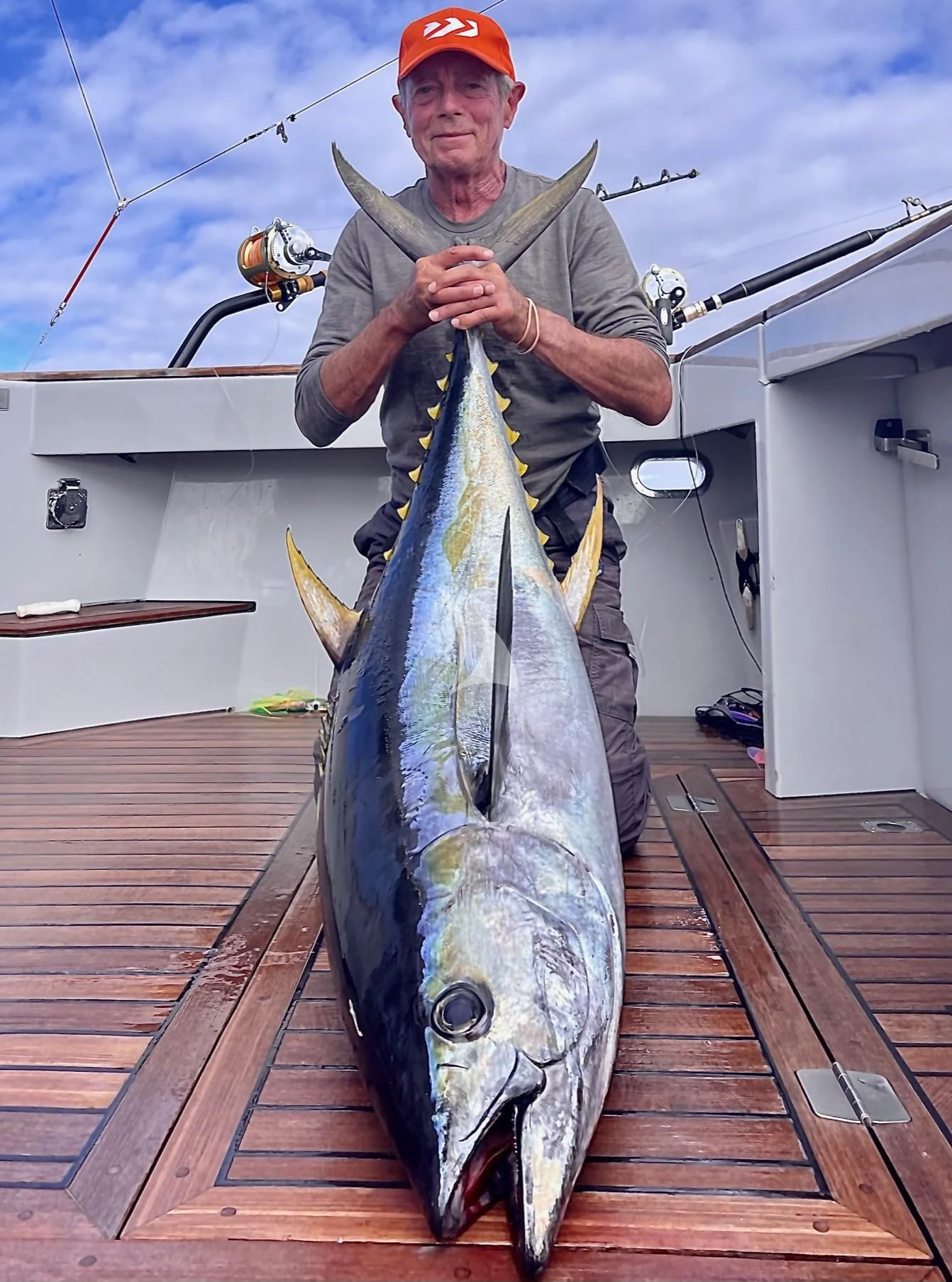 a man holding a fish aboard THE BEAST Yacht for Sale