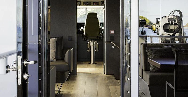 a room with a chair and a couch aboard THE BEAST Yacht for Sale