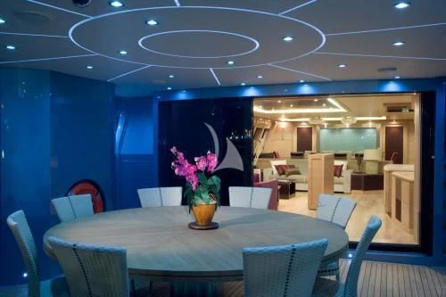 a room with chairs and tables aboard WAVERUNNER Yacht for Sale