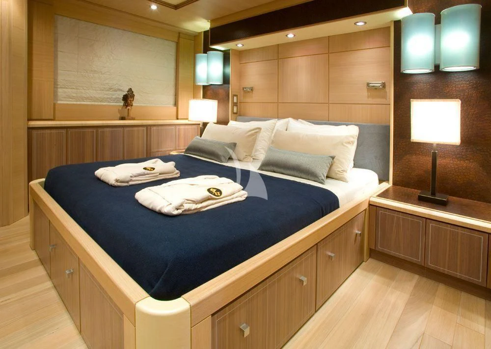 a bed with a blue sheet aboard WAVERUNNER Yacht for Sale