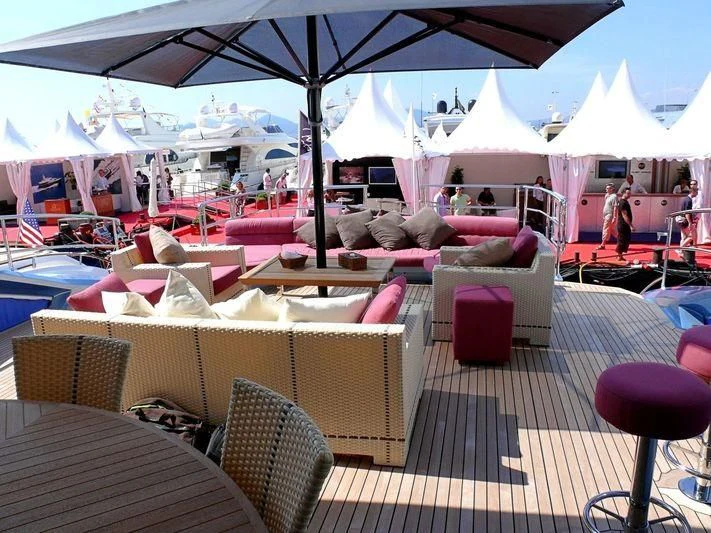 a group of tables and chairs under an umbrella aboard WAVERUNNER Yacht for Sale