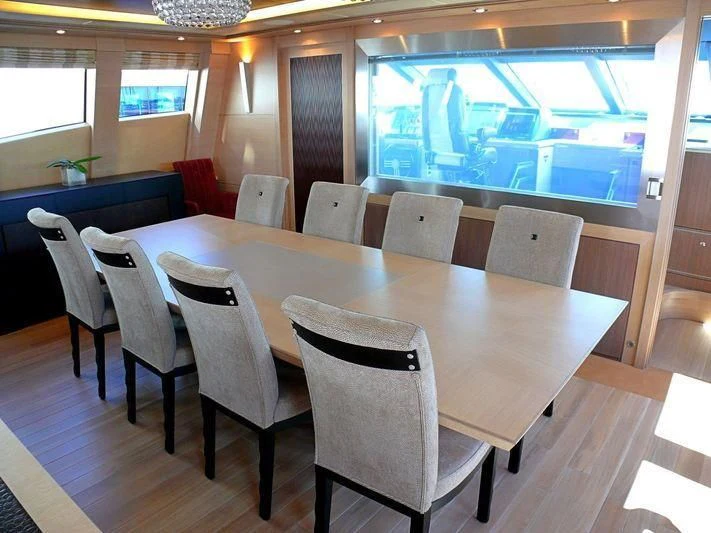a table with chairs around it aboard WAVERUNNER Yacht for Sale