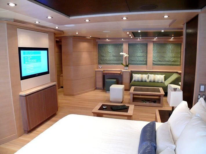 a room with a tv and furniture aboard WAVERUNNER Yacht for Sale
