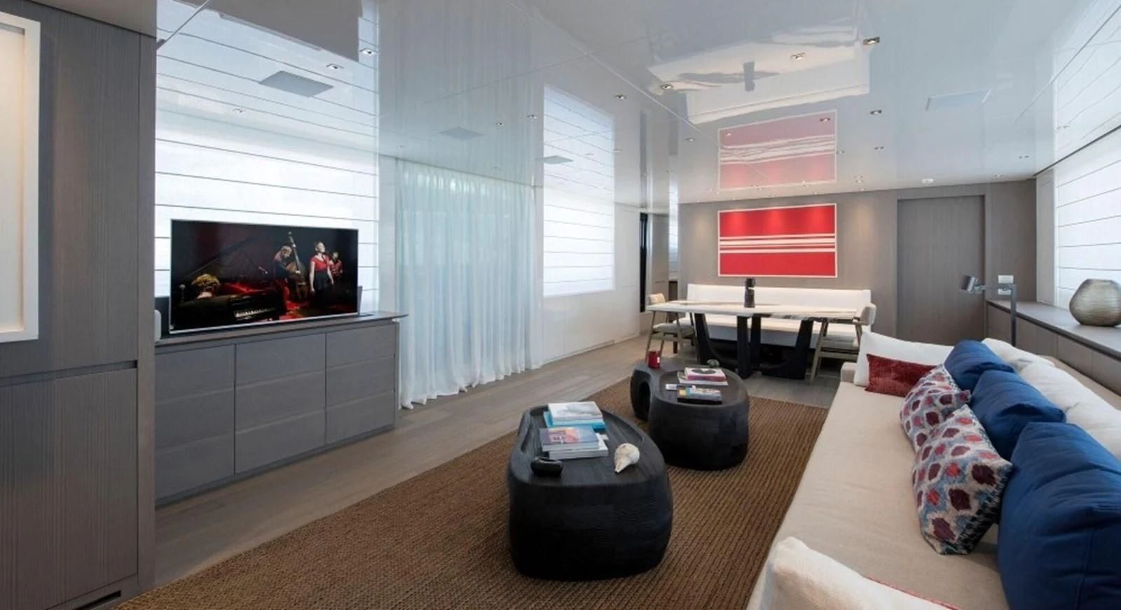 a living room with a tv and furniture aboard DINAIA Yacht for Charter