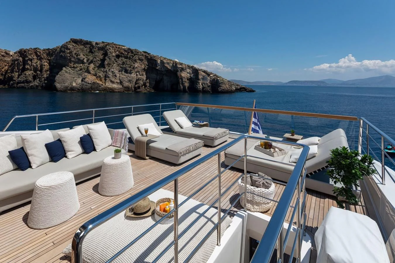 a deck with a pool and lounge chairs on it aboard DINAIA Yacht for Charter