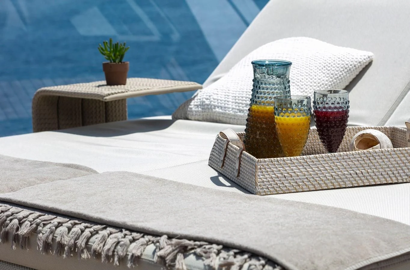 a tray with drinks and a book aboard DINAIA Yacht for Charter