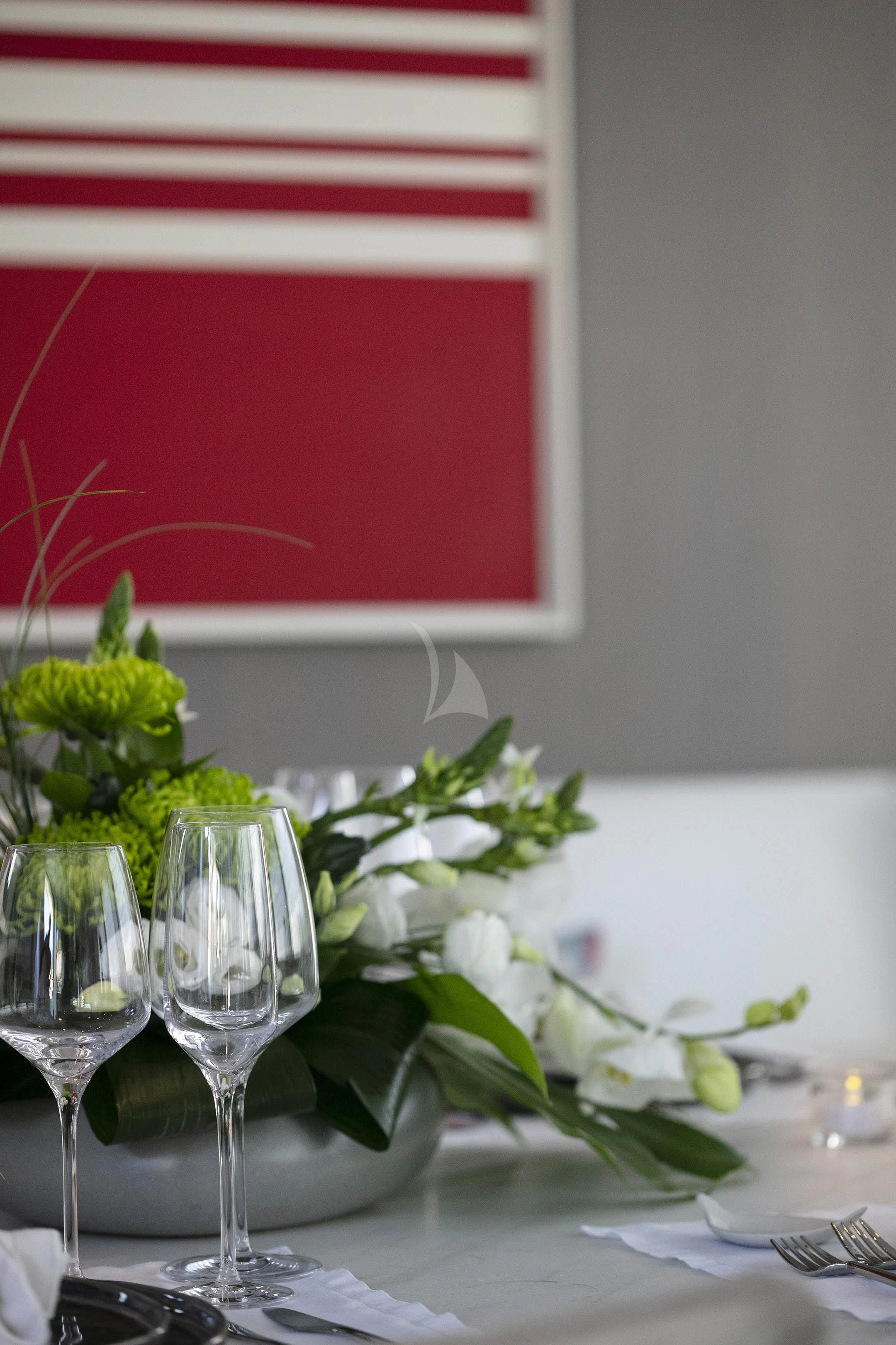 a table with glasses and flowers aboard DINAIA Yacht for Charter