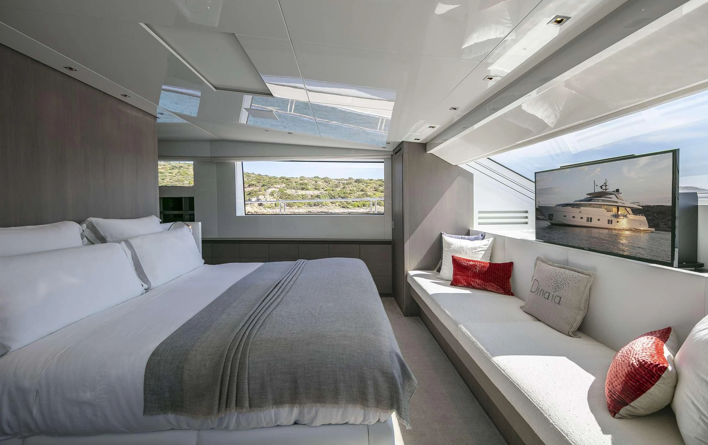a room with a bed and a couch aboard DINAIA Yacht for Charter