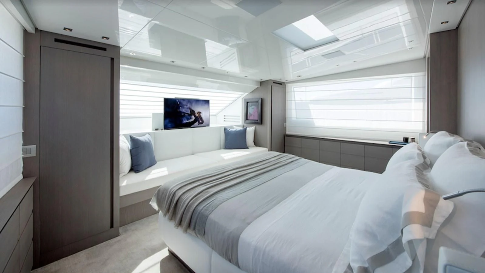 a room with a bed and a television aboard DINAIA Yacht for Charter
