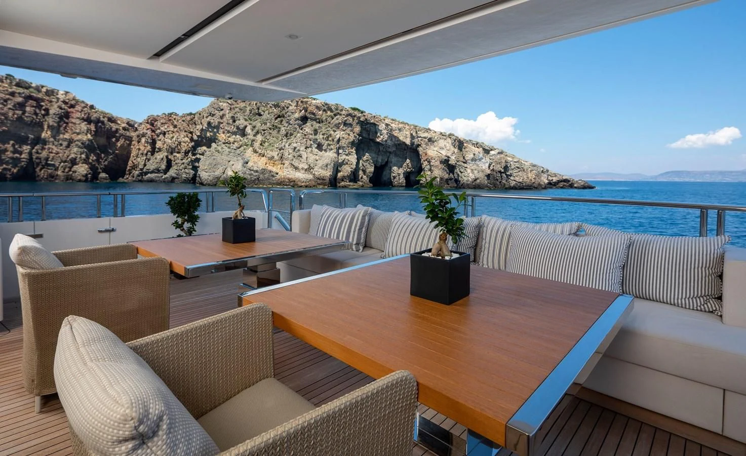 a table and chairs on a patio aboard DINAIA Yacht for Charter