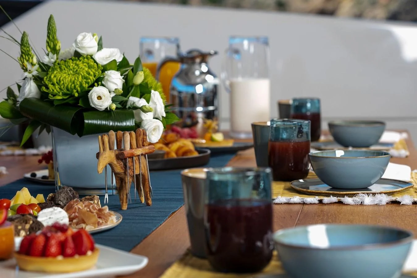 a table with food and drinks aboard DINAIA Yacht for Charter